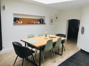 a dining room with a wooden table and chairs at Appartement Héloïse, le charme du Vieux-Lille in Lille