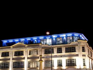 a building lit up in blue at night at Villare Leicester City Centre hotel in Leicester