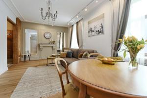 a living room with a table and a couch at Dzirnavu Residense in Rīga