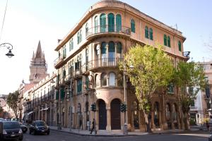 a large building on the corner of a street at B&B Lepanto in Messina