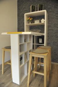 a desk and two stools in a room at Rijeka center- Apartment Flumen in Rijeka