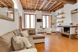 a living room with a couch and a fireplace at Arenula Luxury Apartment in Rome
