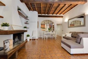 a living room with a couch and a fireplace at Arenula Luxury Apartment in Rome