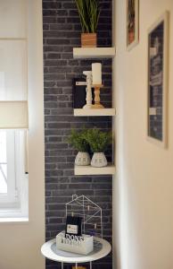 a room with a brick wall with shelves and a table at Rijeka center- Apartment Flumen in Rijeka