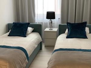 Posteľ alebo postele v izbe v ubytovaní Apartament Zacisze De LUX