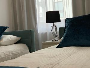 Posteľ alebo postele v izbe v ubytovaní Apartament Zacisze De LUX
