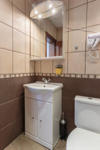 a bathroom with a sink and a toilet and a mirror at СТАИ ЗА ГОСТИ ХАН КРУМ in Burgas City