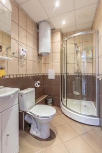 a bathroom with a toilet and a shower and a sink at СТАИ ЗА ГОСТИ ХАН КРУМ in Burgas City