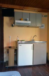 a kitchen with a sink and a refrigerator at Kydonia Rooms in Chania
