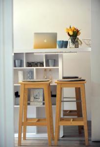 a desk with a laptop and two stools at Rijeka center- Apartment Flumen in Rijeka