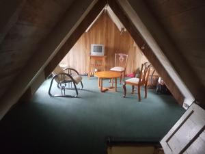a room with a table and chairs in a attic at Silver Hill Select in Spa Spring