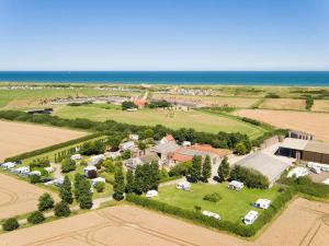 an aerial view of a village with the ocean at The Pollywiggle, Waxham, nr sea palling dog friendly, private walk to the beach in Norwich