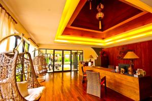 a living room with a wooden table and chairs at Beyond Resort Khaolak - SHA Plus in Khao Lak