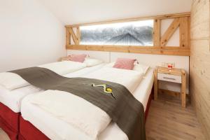 two beds in a room with a window at Oberstdorfer Ferienwelt am Marktplatz in Oberstdorf