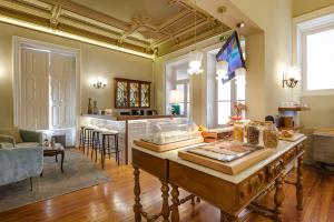 a living room with a table and a kitchen at The Rex Hotel Porto - Mansion House - Private Parking in Porto