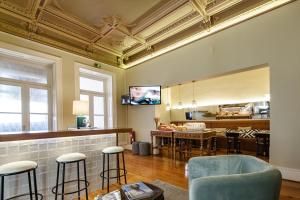 a living room with a table and some chairs at The Rex Hotel Porto - Mansion House - Private Parking in Porto
