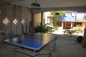 a ping pong table in the middle of a room at Casa 3 Águias in Aveiro