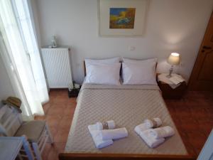 A bed or beds in a room at Melissani House