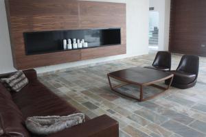 a living room with a couch and a table and chairs at Amphora Hotel & Suites in Paphos