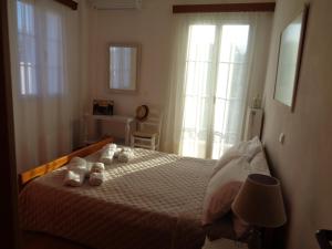 A bed or beds in a room at Melissani House