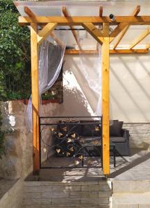 a wooden gazebo with a couch under it at Apartments Split in Split