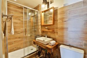 a bathroom with a sink and a shower and a toilet at H&ocirc;tel La Bastide in Hy&egrave;res
