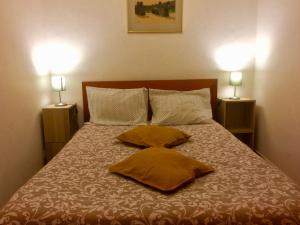 Una cama con dos almohadas y dos lámparas. en Templar Secrets House Beach, en Nazaré