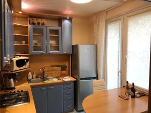 a kitchen with a stainless steel refrigerator and a table at Apartment Sever Hroncova in Košice