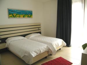 Posteľ alebo postele v izbe v ubytovaní Althea Palace Hotel