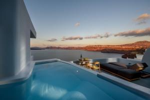 a swimming pool with a view of the water at Avatar Suites in Akrotiri