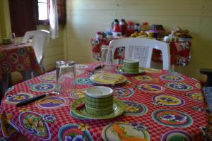 a table with a table cloth with plates and dishes on it at Pousada Avalon Paranapiacaba in Paranapiacaba +29 photos