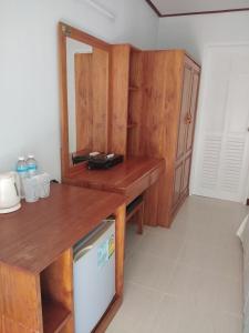 a kitchen with a wooden counter and a refrigerator at Mook Paradise Bungalow in Koh Mook