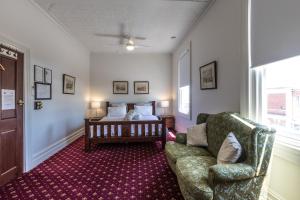 a living room with a couch and a bed at The Corner Hotel Alexandra in Alexandra