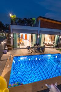 a swimming pool in front of a house at De Nathai Private Pool Villa in Ao Nang Beach