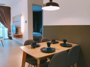 a wooden table with chairs and a dining room at MykeyThe Wave A-17-13A Melaka City in Melaka