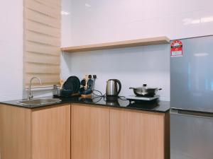 a kitchen with a sink and a refrigerator at MykeyThe Wave A-17-13A Melaka City in Melaka +6 photos