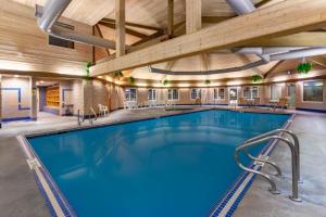 a large swimming pool in a building with a wooden ceiling at Pine Mountain Resort in Iron Mountain