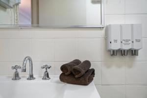 a white towel sitting on top of a towel rack at Garden City Motor Inn in Wagga Wagga