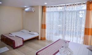 Postel nebo postele na pokoji v ubytování Ceylon Sea Hotel