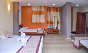 Postel nebo postele na pokoji v ubytování Ceylon Sea Hotel