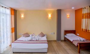 Postel nebo postele na pokoji v ubytování Ceylon Sea Hotel