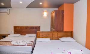 Postel nebo postele na pokoji v ubytování Ceylon Sea Hotel