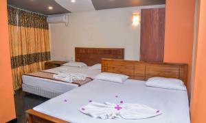 Postel nebo postele na pokoji v ubytování Ceylon Sea Hotel