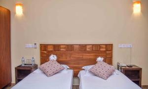 Postel nebo postele na pokoji v ubytování Ceylon Sea Hotel