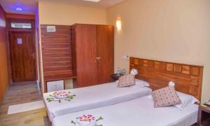 Postel nebo postele na pokoji v ubytování Ceylon Sea Hotel