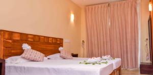 Postel nebo postele na pokoji v ubytování Ceylon Sea Hotel