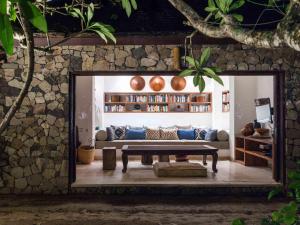 a living room with a couch and a table at Sira Beach House in Tanjung