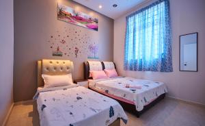 a bedroom with two beds and a window at Esdi Homestay Malacca in Malacca