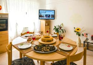 a dining room table with a plate of food on it at Apartment Dora in Umag