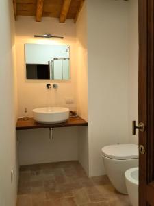 a bathroom with a sink and a toilet and a mirror at Agriturismo Villa Gorgognano in Certaldo